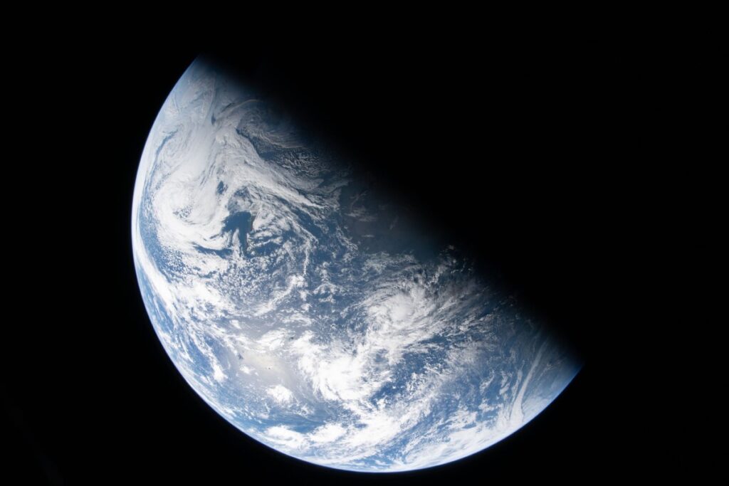 Earth view from Orion spacecraft showing the terminator dividing night and day, taken by NASA astronaut Reid Wiseman during Artemis II mission - Too Lazy Facts
